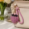 The pink strawberry-shaped keychain is a cute and girlish pendant that is small and portable details Picture